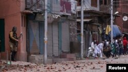 Demonstrators throw stones toward Indian police during clashes after the Eid al-Fitr prayers in Srinagar, India, June 5, 2019.