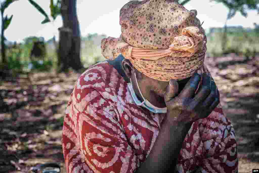 A woman in Lukodi town, Uganda, where dozens were killed in 2004 by the Lord's Resistance Army, weeps as she listens to Dominic Ongwen's verdict on the radio. The International Criminal Court in The Hague, Netherlands, convicted the child soldier-turned-Lord's Resistance Army commander, of war crimes and crimes against humanity.