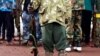 FILE - A former child soldier holds a gun as they participate in a child soldiers' release ceremony, outside Yambio, South Sudan, Aug. 7, 2018. 
