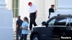 FILE - President Donald Trump, in golf attire, departs the White House for his Trump National Gold Club in Sterling, Virginia, July 14, 2019.