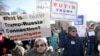 Protesters hold placards and chant slogans during a demonstration called "Emergency Rally to Stand for Democracy," Feb. 26, 2017, in Boston. 
