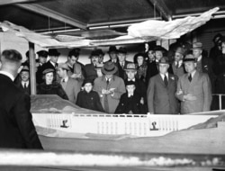 FILE - President Franklin D. Roosevelt, second from right in front, looks at a model of the Grand Coulee Dam, Oct. 2, 1937. Construction of the dam began years earlier; Roosevelt had envisioned the Washington state project would fit into his New Deal under the Public Works Administration.