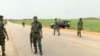 FILE - A still image taken from a video shot on June 25, 2018, shows security officers on the street in Plateau, Nigeria. 
