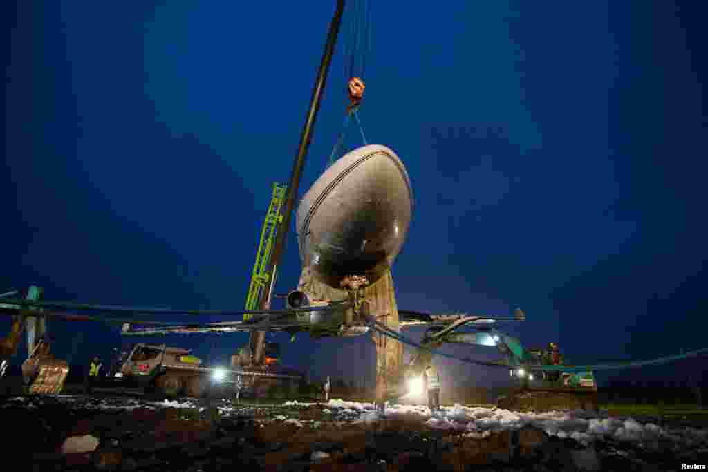 A Star Jet business plane that veered off the runway at the Taizhou International Airport is seen lifted in Yangzhou, Jiangsu province, China.