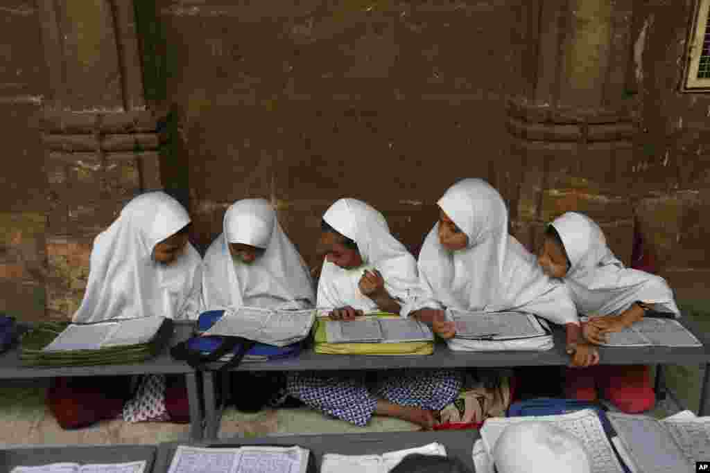 Indian Muslim children learn to read the Quran at Jama Masjid mosque on the first day of the holy Muslim month of Ramadan in Ahmadabad.