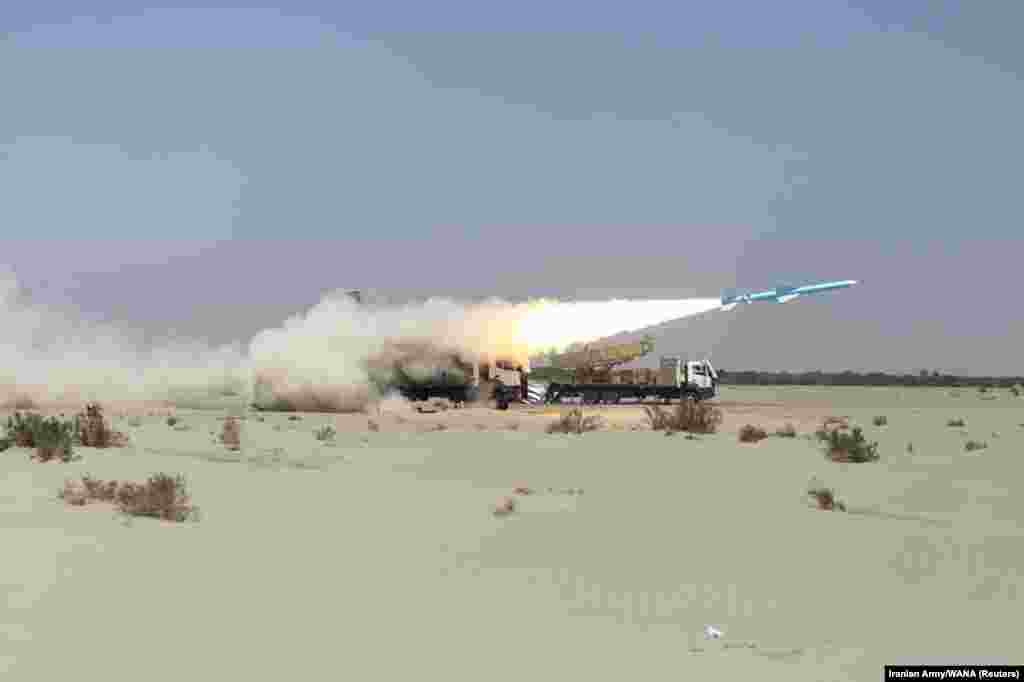 Iran's military launches a missile during a navy exercise in the Gulf of Oman.