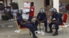 FILE - Zambian police sits at the Civic Center in Lusaka, Zambia, as election volunteers carry ballot boxes, September 22, 2011.