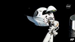 FILE - The SpaceX Crew Dragon capsule is pictured, March 3, 2019, about 20 meters (66 feet) from the International Space Station's Harmony module.
