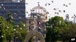 FILE - Doves fly by the Atomic Bomb Dome during the ceremony to mark the 61st anniversary of the world's first atomic bombing at Hiroshima Peace Memorial Park in Hiroshima, western Japan, Aug, 6, 2006 (AP)