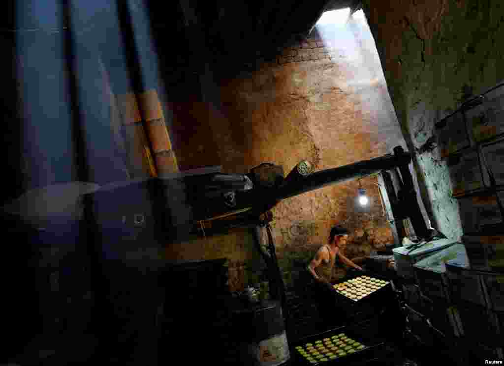 A man prepares cookies at a small traditional factory on the first day of the holy month of Ramadan in Kabul, Afghanistan.