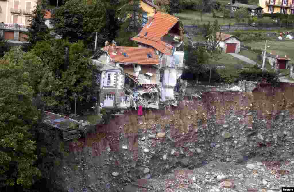 An aerial view shows damaged houses in Saint-Martin-Vesubie, southern France, as clean-up operations continue after storm Alex hit the Alpes-Maritimes department, bringing record rainfall and causing heavy flooding that swept away roads and damaged homes.