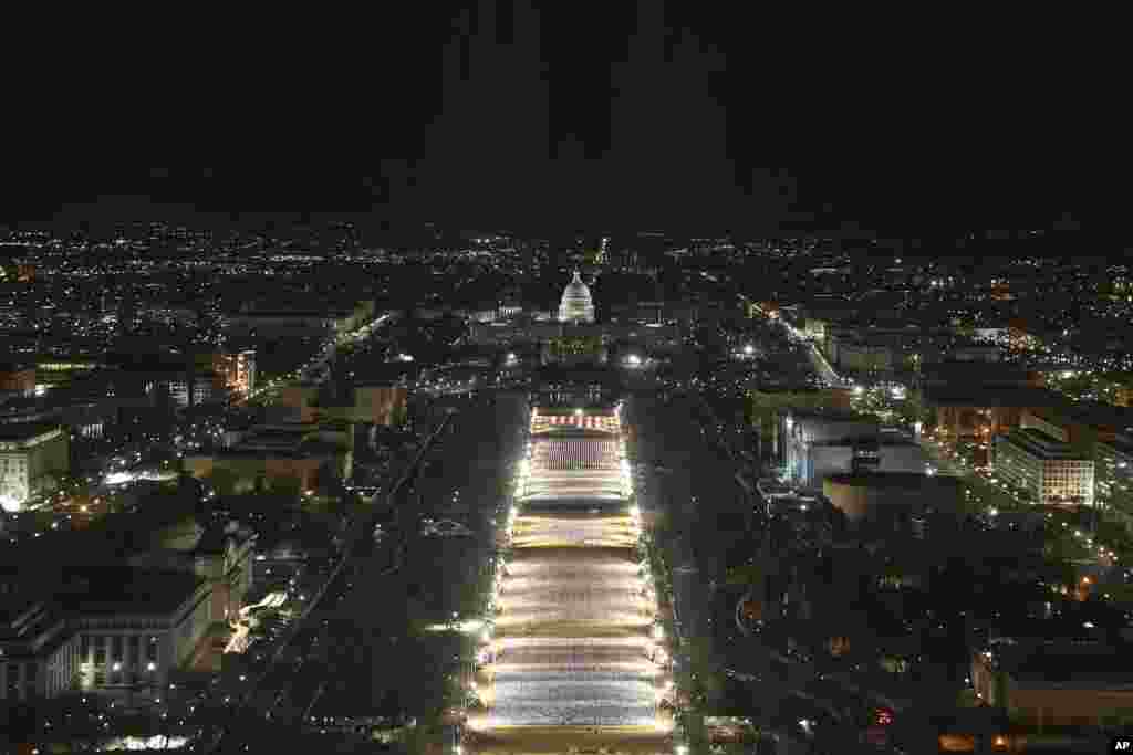 The U.S. Capitol building is prepared for the inauguration ceremonies for President-elect Joe Biden as the "Field of Flags" are illuminated on the ground on the National Mall, Jan. 18, 2021. in Washington, D.C.
