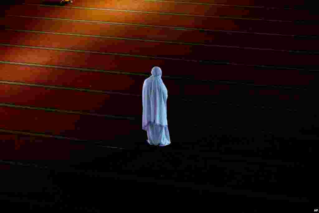 A Muslim woman prays at the Istiqlal Mosque in Jakarta, Indonesia.