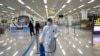 State Commission of Quality Management staff member in protective gear carries a disinfectant spray can as they continue to check the health of travelers and inspect and quarantine goods at the Pyongyang Airport in Pyongyang, North Korea, Feb. 1, 2020.