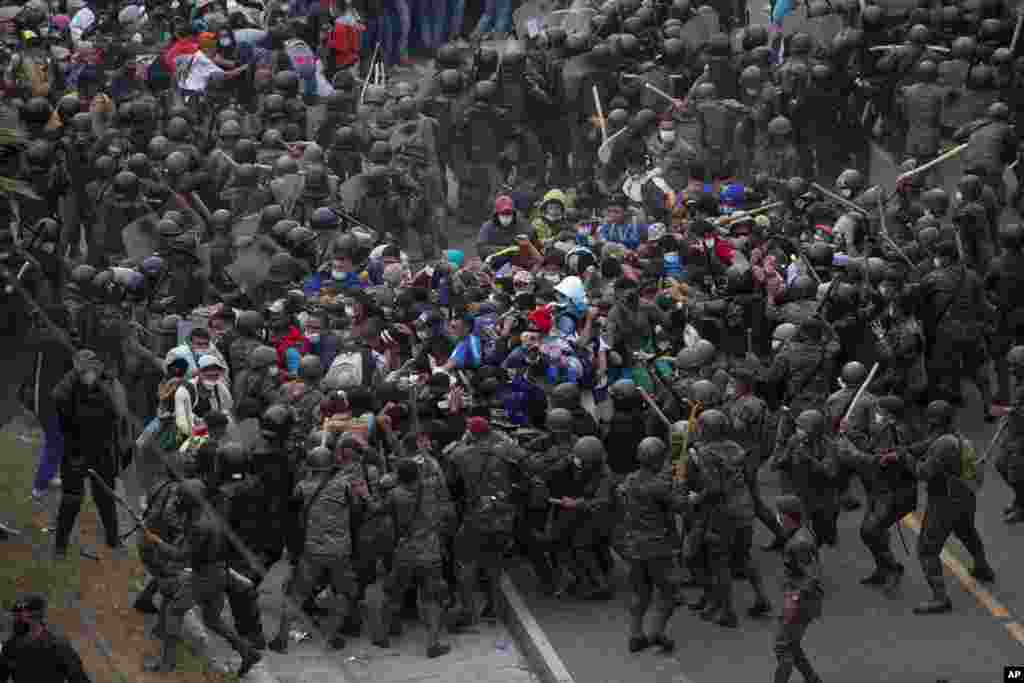 Honduran migrants clash with Guatemalan soldiers in Vado Hondo, Guatemala. Authorities estimated that as many as 9,000 Honduran migrants crossed into Guatemala as part of an effort to form a new caravan to reach the U.S. border. 