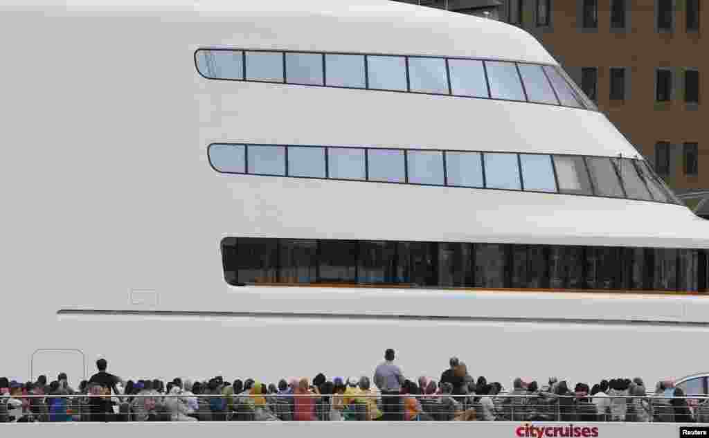 Passengers on a river-cruise boat pass a superyacht named "Motor Yacht A," owned by Russian tycoon Andrey Melnichenko, moored on the River Thames in London, Britain, Sept. 6, 2016.