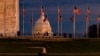 FILE - The US Capitol Building is seen past the Washington Monument as the sun sets on Dec. 26, 2020 in Washington, DC. 