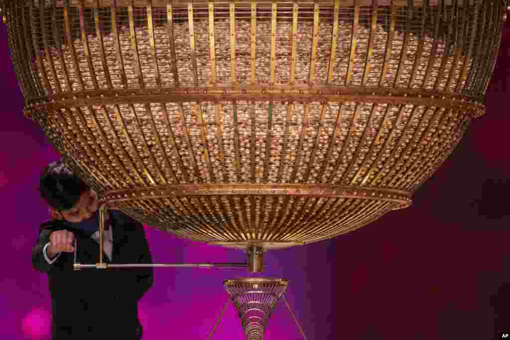 A ball bearing a ticket number falls from a giant drum at Madrid's Teatro Real opera house during Spain's bumper Christmas lottery draw known as El Gordo, or The Fat One, in Madrid.