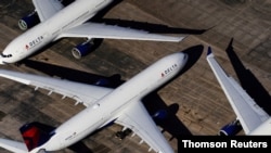 FILE - Delta Air Lines passenger planes are seen at Birmingham-Shuttlesworth International Airport in Birmingham, Alabama, March 25, 2020.