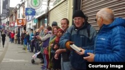 Community members form a human chain to help moves books from the October Books store in Southhampton, England on October 28, 2018. (The Southampton Collective)