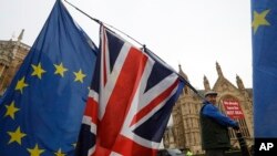 An anti-Brexit campaigner waves flags in Westminster in London, Dec. 4, 2018.