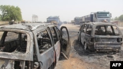 FILE - Burmed cars are seen after an attack by suspected members of the Islamic State West Africa Province in Auno, Nigeria, Feb. 9, 2020. A military convoy came under rocket fire from ISWAP militants between Dikwa and Marte on Sept. 24, 2021, leaving eight troops dead.