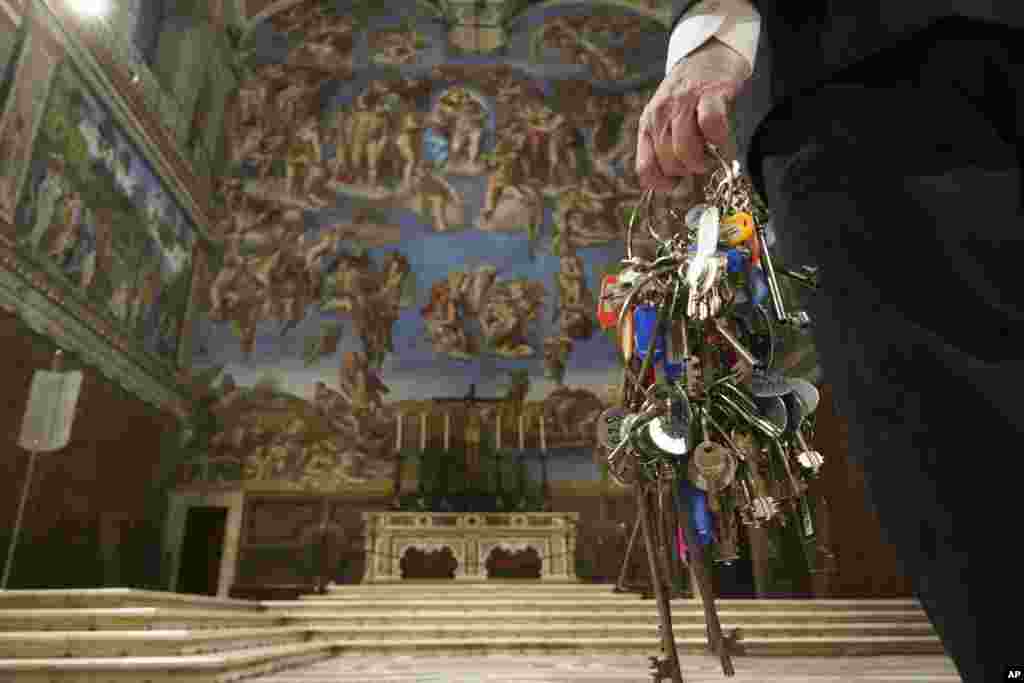 Gianni Crea, the Vatican Museums chief "Clavigero" keys keeper, walks through the Sistine Chapel as he prepares to open the museum, at the Vatican.