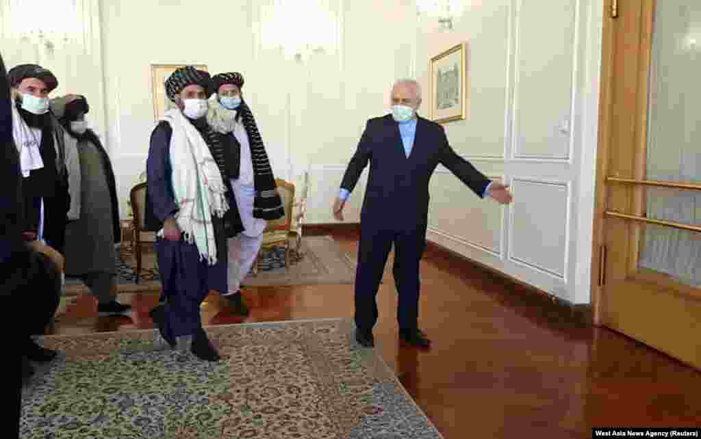 Iran's Foreign Minister Mohammad Javad Zarif meets with Taliban political chief Mullah Abdul Ghani Baradar in Tehran.