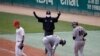 In this Tuesday, May 5, 2020, file photo, first base umpire Lee Ki-joong, wearing a mask and gloves as a precaution against the new coronavirus, makes a call during a baseball game between Hanwha Eagles and SK Wyverns in Incheon, South Korea.