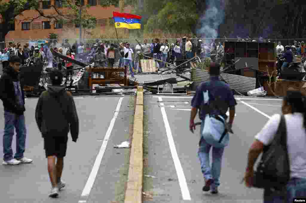 Supporters of opposition leader Leopoldo Lopez stand at a barricade during a protest against Nicolas Maduro's government in a middle-class neighborhood in Caracas, Feb. 20, 2014.