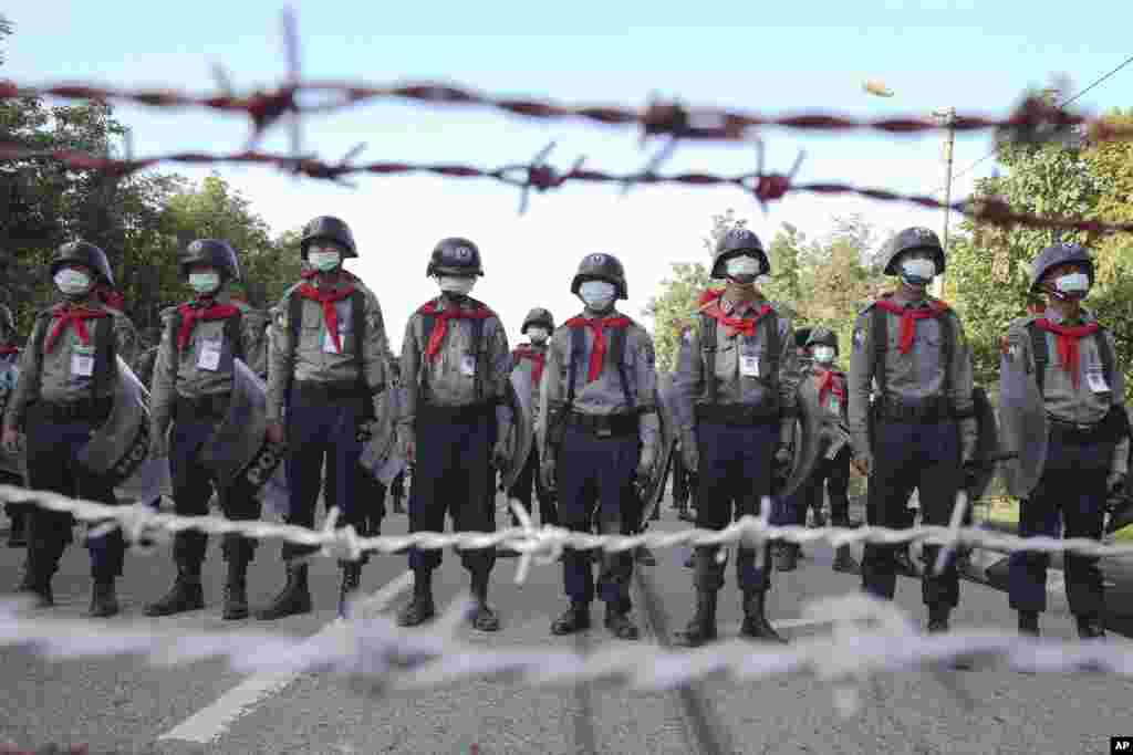 Police stand guard behind barbed wire as they attempt to stop protesters outside Union Election Commission office in Naypyitaw, Myanmar. The military-backed main opposition party said it rejected last Sunday's election results, citing unfairness.