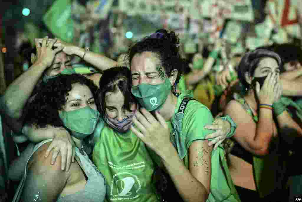 Pro-choice activists celebrate after the Senate approved a bill to legalize abortion outside the Congress in Buenos Aires, Brazil.