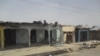 Bloodstains seen on the street and damage buildings following a suicide bomb explosion at a World cup viewing centre in Damaturu, Nigeria, Wednesday, June 18, 2014. Police say 14 people were known to have died in the bombing of an outdoor World Cup viewin