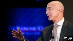 FILE- In this Sept. 13, 2018, file photo Jeff Bezos, Amazon founder and CEO, speaks at The Economic Club of Washington's Milestone Celebration in Washington. 