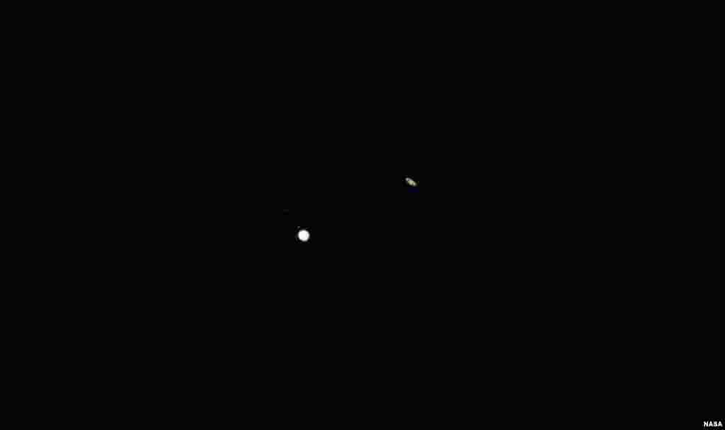 Jupiter, left, and Saturn, right, are seen during the “great conjunction” where the two planets appear a tenth of a degree apart from one another, Dec. 21, 2020, near Chapel Hill, North Carolina.