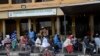 FILE - Muslim faithfuls wait to be administered a dose of Astrazeneca's Vaxzevria COVID-19 vaccine at Secretariat Community Central Mosque, Alausa, Ikeja in Lagos, Nov. 26, 2021.