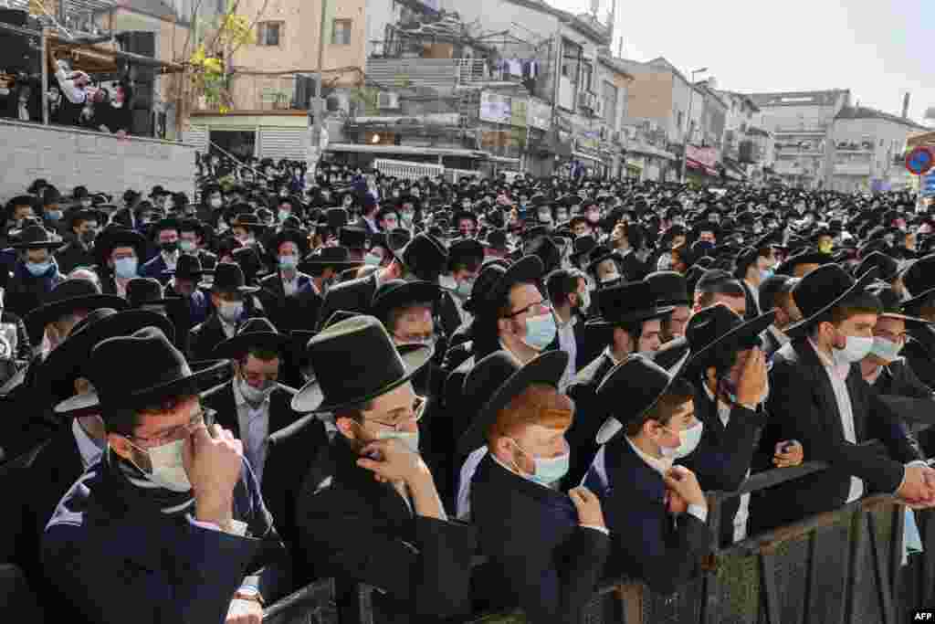 Despite the coronavirus pandemic, thousands of Ultra-orthodox Jewish men attend the funeral of Rabbi Aharon David Hadash, the spiritual leader of the Mir Yeshiva, in Jerusalem's Ultra-Orthodox neighbourhood of Beit Yisrael.