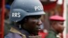 A police officer stands guard during a demonstration calling on government to rescue kidnapped school girls of a government secondary school Chibok, during workers day celebration in Lagos, Nigeria. Thursday, May, 1. 2014.
