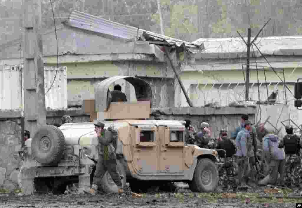 Afghan army and police surround the area after a multi-pronged attack on a police station in Jalalabad, Afghanistan, March 20, 2014.