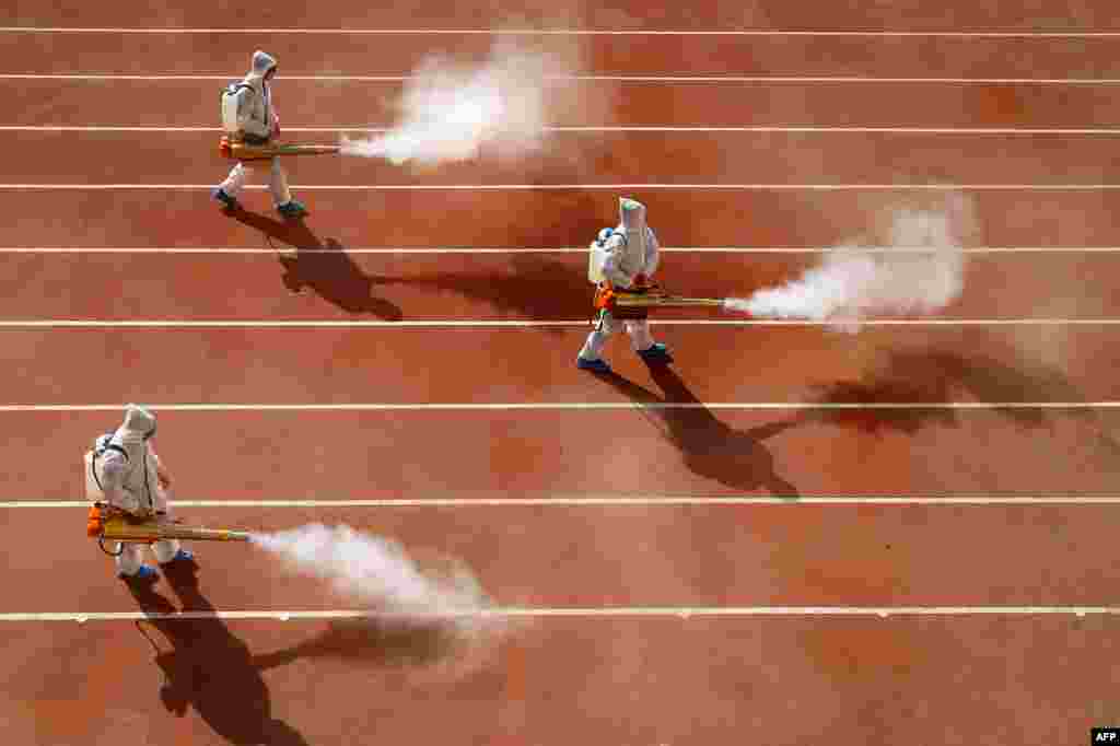 Workers spray disinfectant in the playground of a primary school in Huaibei, in eastern China's Anhui province, as the school prepares for the start of a new term.
