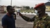 A soldier checks the body temperature of a visitor to the 68 Nigerian Army Reference Hospital at Yaba in Lagos, Feb. 28, 2020.