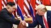 FILE - North Korea's leader Kim Jong Un (L) and U.S. President Donald Trump shake hands during a meeting on the south side of the Military Demarcation Line that divides North and South Korea, in the Demilitarized zone (DMZ) of Panmunjom, June 30, 2019. 