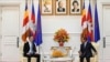 Hungarian Foreign Minister Peter Szijjarto, left, talks with Cambodian Prime Minister Hun Sen during a meeting at Peace Palace in Phnom Penh, Cambodia, Tuesday, Nov. 3, 2020. (Pool Photo via AP)