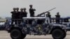 Philippine air force personnel standing on a humvee vehicle during the Philippine Air Force anniversary celebration at the former US air base, Clark air base, Pampanga province north of Manila, July 1, 2013.
