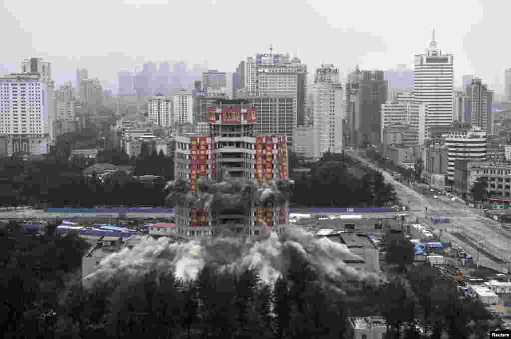 Worker's Cultural Palace is demolition by explosives in Kunming, Yunnan province, China. The 70-meter-high building had been a recreational center for residents since completion in 1982. 