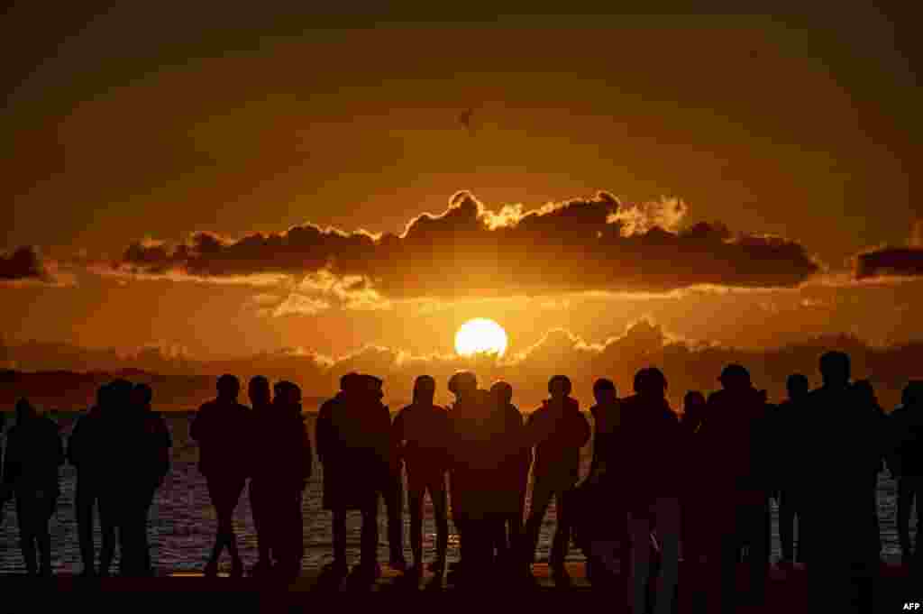 People gather at Southern Beach of Chigasaki to watch the sunrise on New Year's Day in Kanagawa Prefecture, southwest of Tokyo.