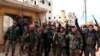 In this photo released Feb. 16, 2020 by the Syrian official news agency SANA, Syrian army soldiers flash the victory sign in the Rashideen neighborhood, in Aleppo province, Syria. 