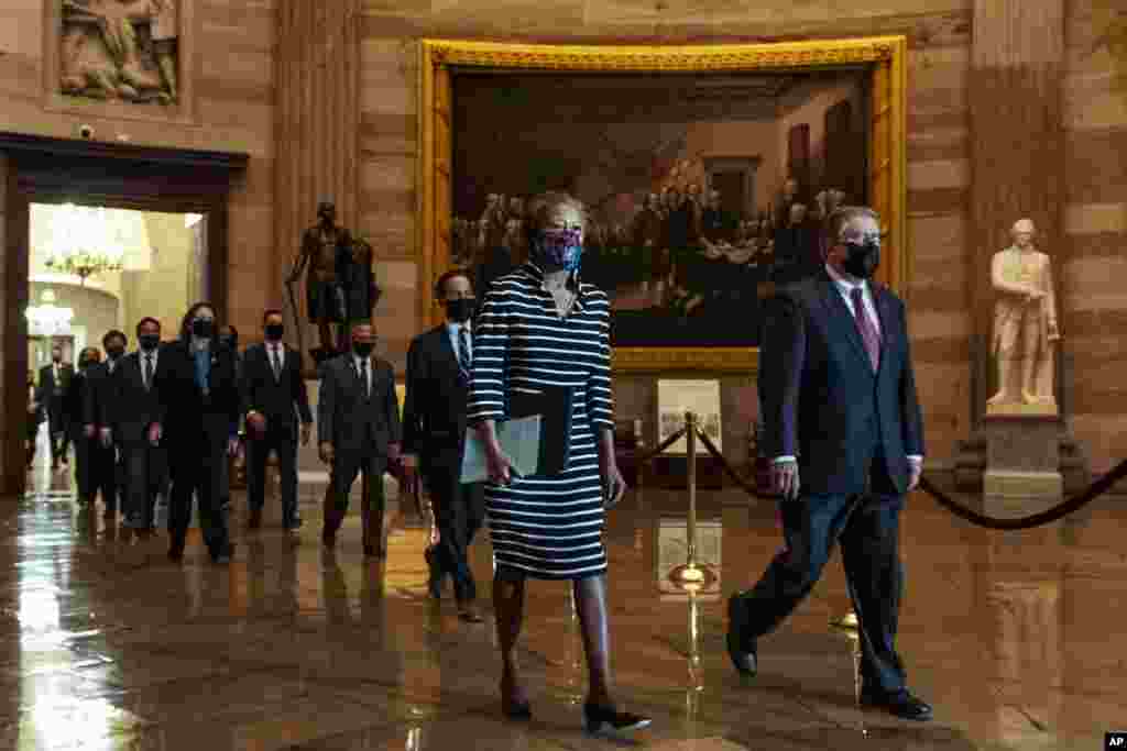 Clerk of the House Cheryl Johnson along with acting House Sergeant-at-Arms Tim Blodgett, lead the Democratic House impeachment managers as they walk through Statuary Hall in the Capitol, to deliver to the Senate the article of impeachment alleging incitement of insurrection against former President Donald Trump, Jan. 25, 2021.