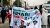 All Progressives Congress (APC) supporters hold a banner with a photograph of former military ruler Muhammadu Buhari in Lagos, Nigeria, Dec. 10, 2014.