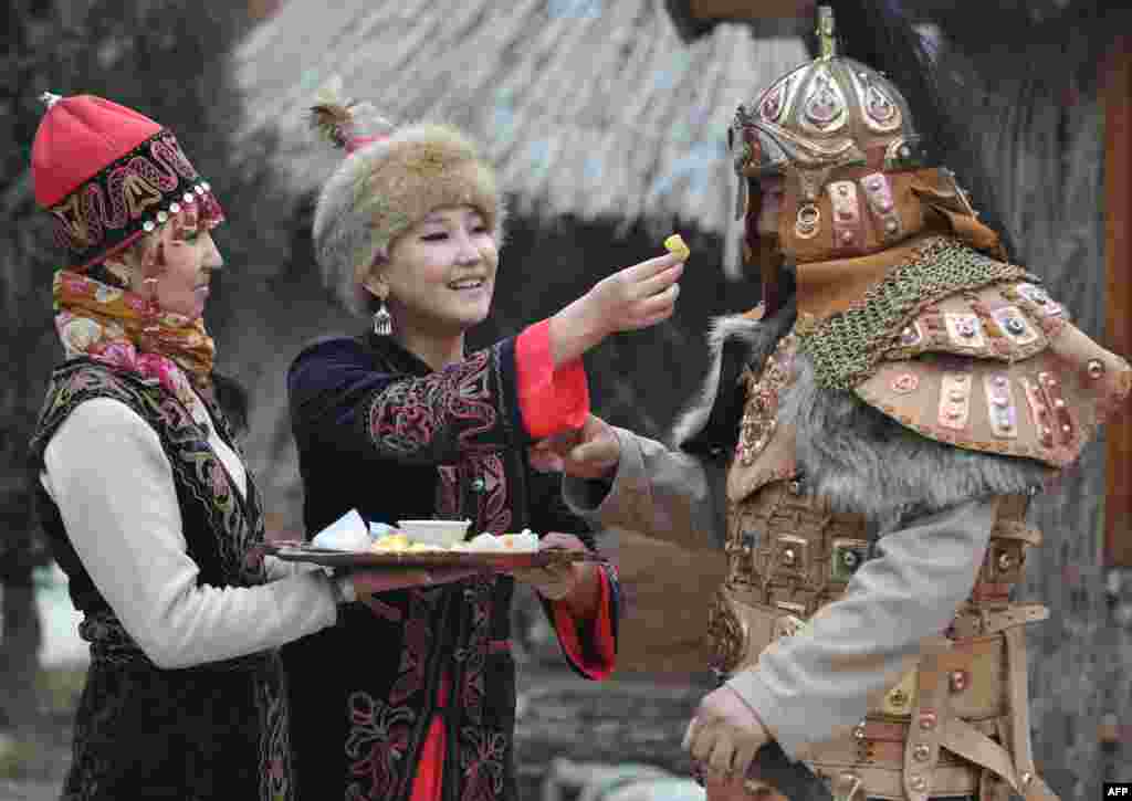 Wearing their traditional costumes Kyrgyz women and a man take part in the celebrations of Nowruz (New Year) in the outskirts of the Kyrgyzstan's capital Bishkek. Nowruz, "The New Year" in Farsi, is an ancient festival marking the first day of spring in Central Asia.
